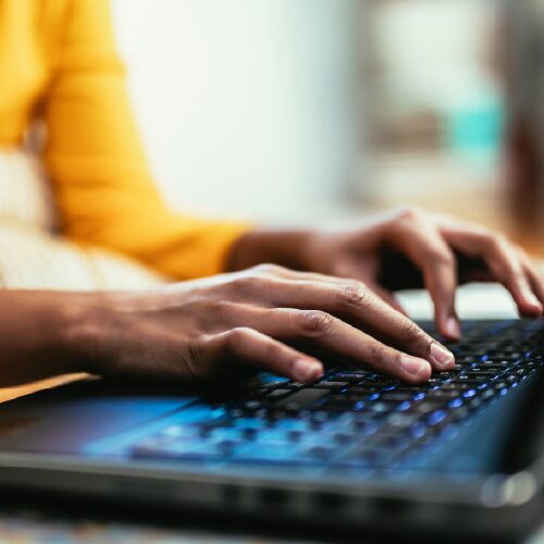 Hands typing on keyboard.